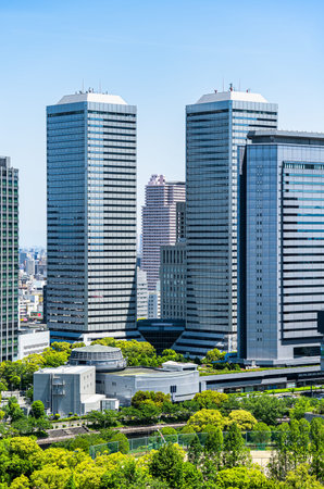 Modern glass skyscrapers seen from the upper floors of Osaka Castle, Japan.