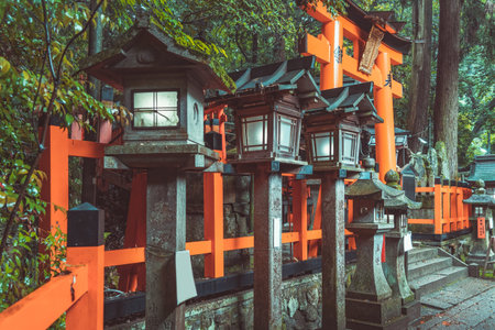 Traditional japanese stone toro lanterns at Fushimi Inari Taisha in Kyoto. (English translation of the japanese text: religious blessings)の写真素材