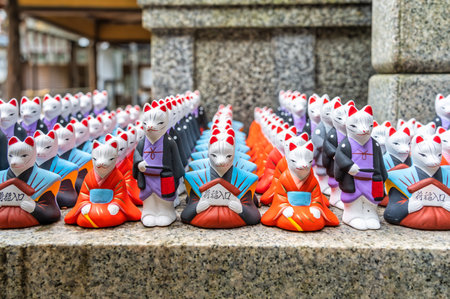 Many fox figurines and statues at Fushimi Inari Shrine, Kyoto Japan. ( Translation of the text from japanese : The rice entrance).の写真素材