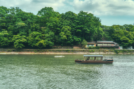 Traditional boat ride on Katsura river in Arashiyama district, Kyotoの写真素材