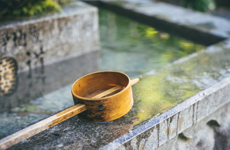 Isolated traditional japanese bamboo wooden laddle. Purification water fountain chozubachi.の写真素材