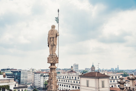 View from the rooftop of the Milan Cathedral (Duomo di Milano), one of the most famous Gothic cathedrals in the world, overlooking the city of Milan, Italyの写真素材