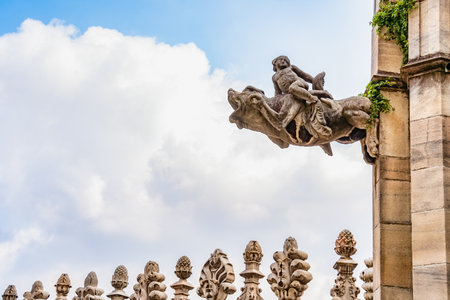 Close-up of a dramatic gargoyle sculpture on the rooftop of the Duomo di Milano (Milan Cathedral), Italyの写真素材