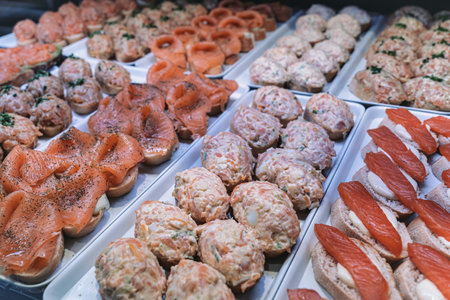 Assorted salmon tapas on display in Mercado de San Miguel, Madrid.の写真素材