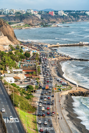 Heavy traffic during daylight with many cars on the coastal cliff side street in Limaの写真素材