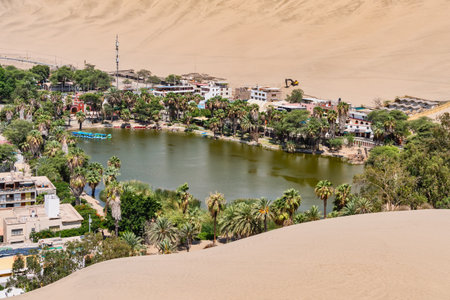 View of the Huacachina Oasis lagoon and the sand dunes in Ica, Peruの写真素材