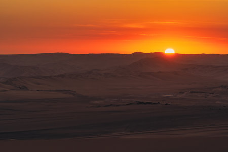 Golden sunset over the vast dunes of the Ica Desert near Huacachina, Peru.の写真素材