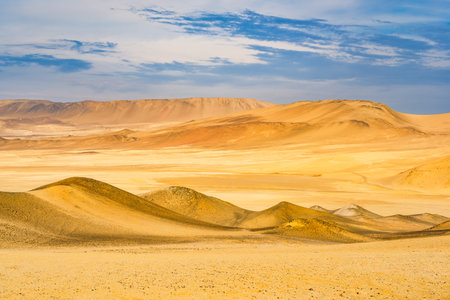 Desert dunes stretch across the arid landscape of Paracas National Reserve in Peru.の写真素材