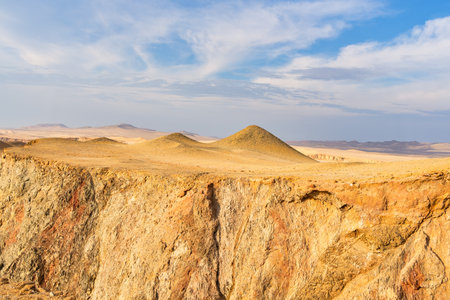 Desert dunes stretch across the arid landscape of Paracas National Reserve in Peru.の写真素材