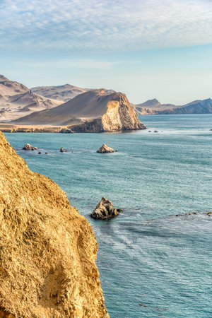 Coastal cliffs and the desert dunes in Paracas National Reserve, Peru. Dramatic landscape with El Playon beach in the distance.の写真素材