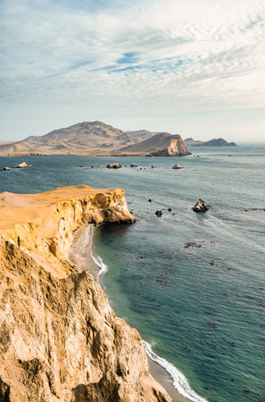 Coastal cliffs and the desert dunes in Paracas National Reserve, Peru. Dramatic landscape with El Playon beach in the distance.の写真素材