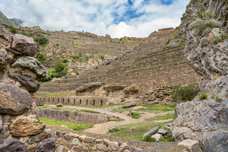 Ollantaytambo, Peru - March 17, 2025: Tourists exploring Ollantaytambo Archaeological Site, a major Inca ruin and popular attraction in the Sacred Valleyのeditorial素材