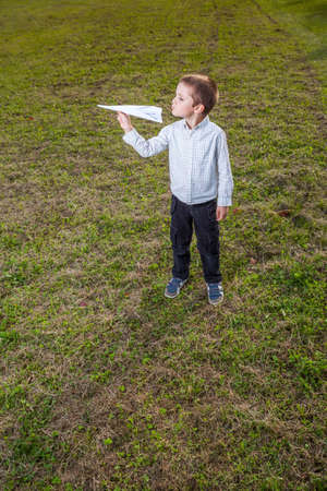 child playing throwing a paper airplaneの写真素材