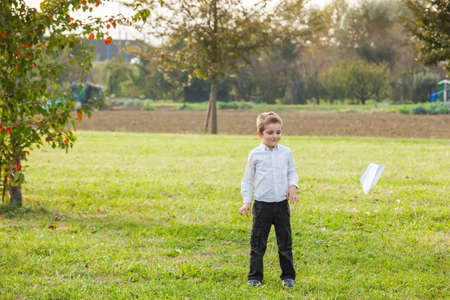 child playing throwing a paper airplaneの写真素材