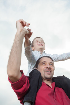 Dad holding his child on shouldersの写真素材