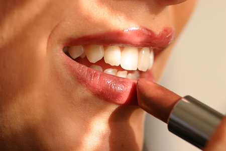 woman applying lipstickの写真素材
