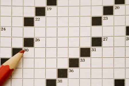 crossword page and a red pencilの写真素材
