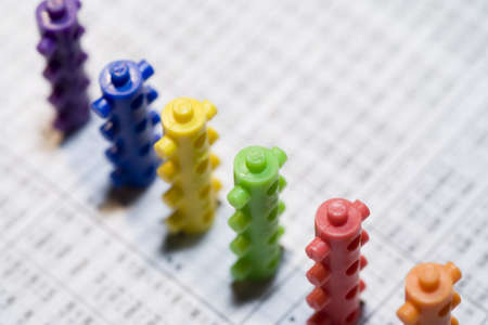 building toy blocks over a financial newspaperの写真素材