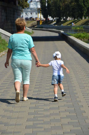 grandmother and granddaughter for a walkの写真素材
