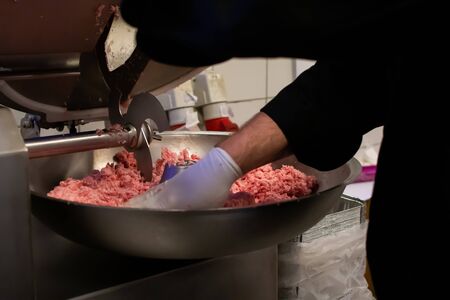 Chef cook preparing meatloaf composition at the grinder machineの写真素材