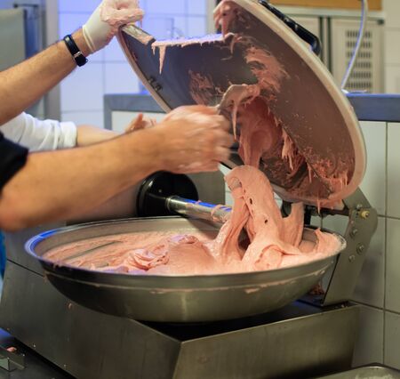 Chef cook preparing meatloaf composition at the grinder machineの写真素材