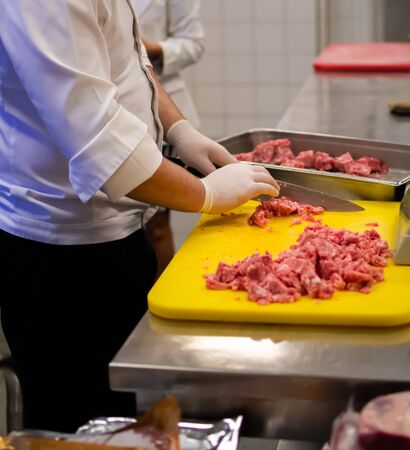 Chef cook preparing meatloaf composition at the grinder machineの写真素材