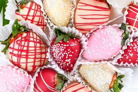Chocolate dipped strawberries dessert mix ideal for Valentine's Day, Mother's Day, Woman's Day, brunch buffet, birthday or name day celebration party, romantic candy bar with spring March flowersの写真素材