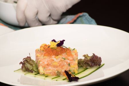 Chef with white hand gloves preparing food during brunch buffetの写真素材