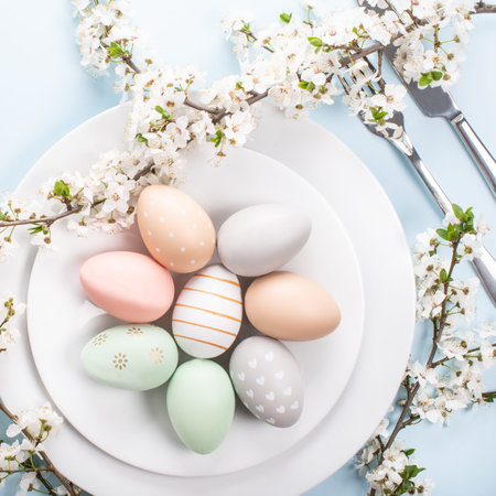 Easter table setting, holiday table home decor idea, flat lay composition with white plates,...
