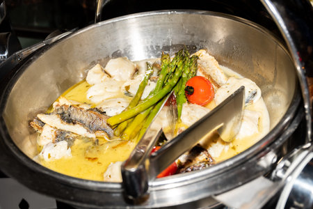 Freshly prepared on the oven fish salmon, trout, seafood dish during brunch buffet or catering...