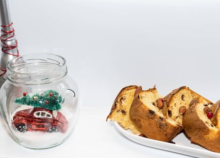 Red car in a jar festive Christmas toy decoration in a transparent globe with snow flakes. Festive silver decorations for holidays season. Greeting card visual for merry Christmas wishesの写真素材