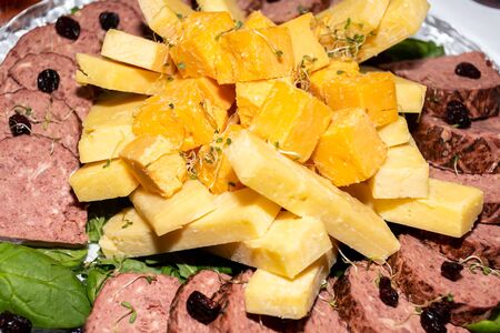 Mix of cheese cuts on a platter, during brunch buffet. Tasty assortment of fresh cheese selection, various types of dairy products, presented during brunch buffet. French or Italian appetizer plattersの写真素材