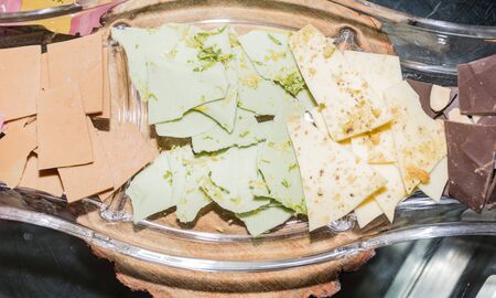 Thin slices, small pieces of colored artisan homemade chocolate snaps bites chipsの写真素材