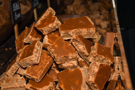 A stack of homemade caramel. Groups of caramel candy, isolated on the table counter at the market....