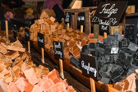 A stack of homemade caramel. Groups of caramel candy, isolated on the table counter at the market. Toffee caramel candy close-up isolatedの写真素材