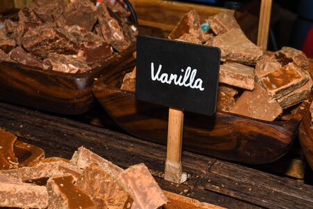 A stack of homemade caramel. Groups of caramel candy, isolated on the table counter at the market. Toffee caramel candy close-up isolatedの写真素材