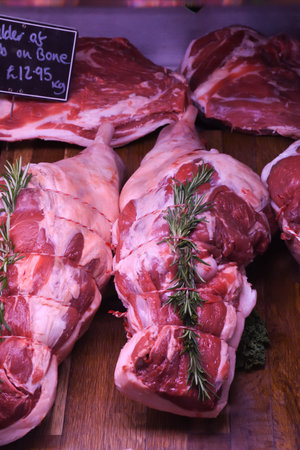 Various Meat cuts exposed in the butchery fridge counter. Raw meat in assortment in a butcher shop