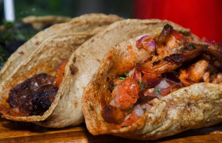 Street food displayed during food festival. Mexican, Indian, Asian, British specialties. Fresh Food Buffet Brunch Catering Dining Eating Party Sharing Conceptの写真素材