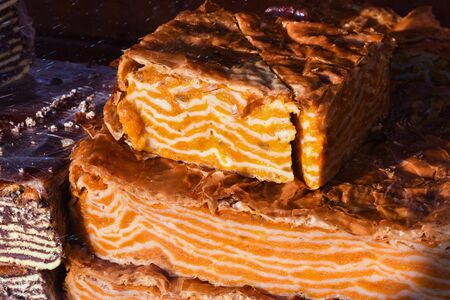 Traditional homemade artisanal apple or pumpkin pie served in a tray with powdered sugar on top to cover it. Romanian traditional bakery pastry recipe sold at food festivalの写真素材