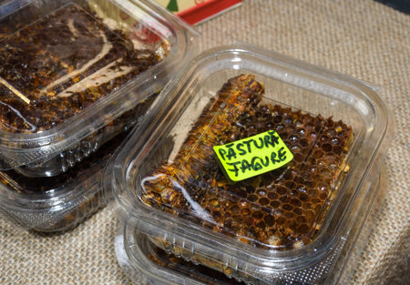 Honey produce for sale during farmers market. Honey, honey comb, polen, wax, bamboo dipperの写真素材