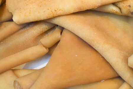 Traditional romanian sorici, pork skin for sale during food festival, pile stack on counter topの写真素材