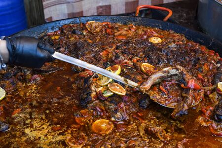 Traditional fish stew being prepared in a rustic bowl over a wood background. Fresh Food Buffet Brunch Catering Dining Eating Party Sharing Conceptの写真素材