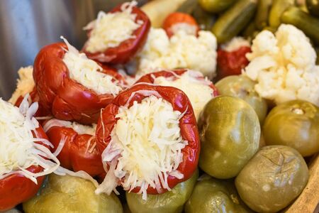 Assorted mix of pickles in sunlight during food festival. Pickled vegetables like red peppers, cucumbers, cauliflower. Country fair or farmer marketの写真素材