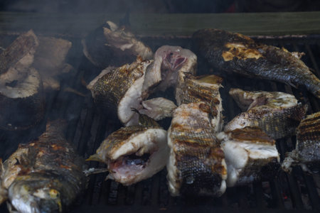 Freshly grilled fish on counter top stall, during seafood festival, street food market. Red sea...