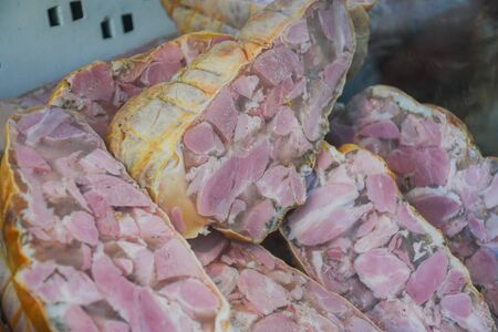 Pork chop with boiled animal organs: tongue, heart, kidneys, meat and garlic. Romanian traditional Christmas specialty, winter appetizer named "toba"の写真素材