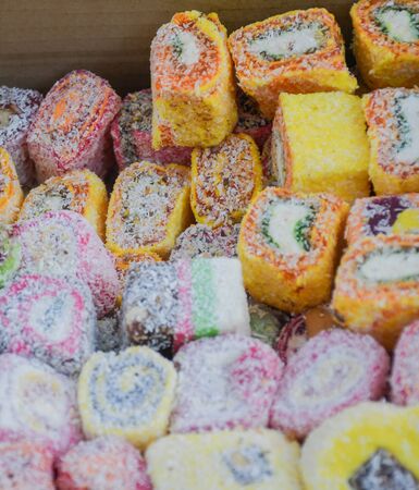 Various types or many colorful assortment of Turkish delights rolls for sale in a shop in Istanbul, or on the street during street food festival. Lokum, a specific Turkey dessert sweets on the marketの写真素材