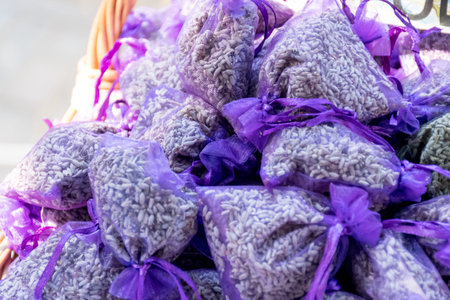 Pouch with lavender in a wooden basket. Fragrant bag of lavender flowers. Sprigs of lavender near...