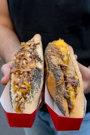 Sausage hot dog during fast food festival event. Outside catering or outdoor party grab and go dish. Outside catering. Food Buffet Catering Dining Eating Party Sharing Concept.Pork sausage, sauerkrautの写真素材