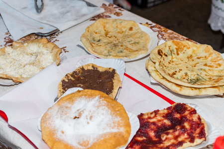 Homemade traditional hungarian dish named langosi during food festival, freshly baked or deep fried...