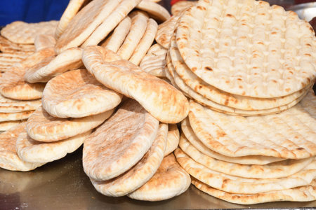 Pile of fresh pita flat bread. Gluten free lebanese or greek specialty. Grilled or oven baked. Food...